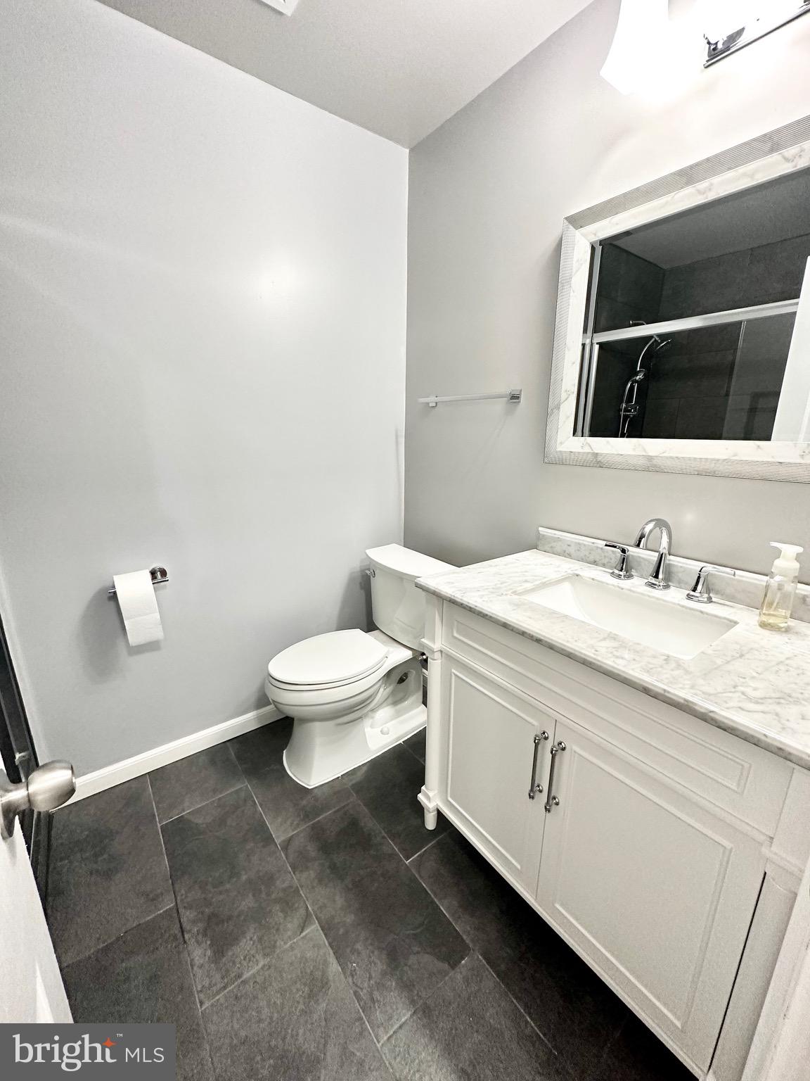 12312 Loch Carron Circle Fort Washington, MD 20744 - Photo 37 of 57 a bathroom with a granite countertop toilet sink mirror and vanity