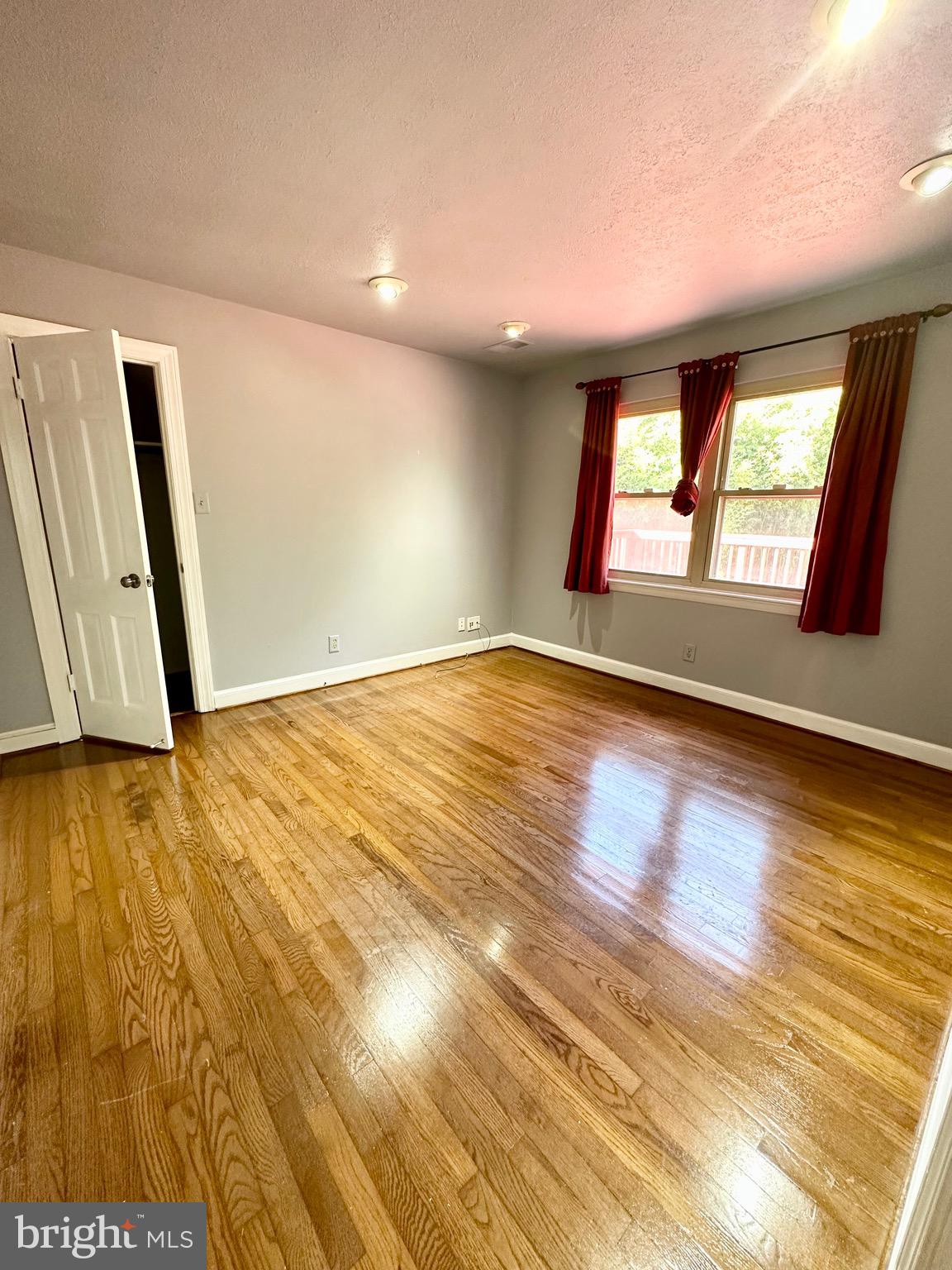 12312 Loch Carron Circle Fort Washington, MD 20744 - Photo 39 of 57 a view of an empty room with glass door and wooden floor