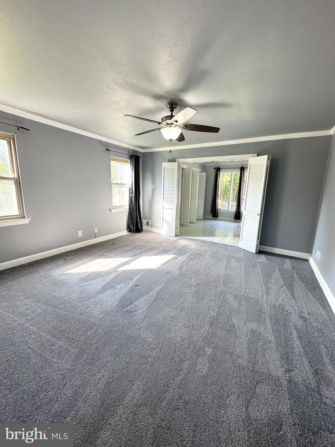 12312 Loch Carron Circle Fort Washington, MD 20744 - Photo 9 of 57 an empty room with windows and chandelier fan