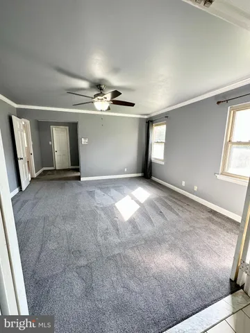 a bathroom with a granite countertop sink mirror and cabinets