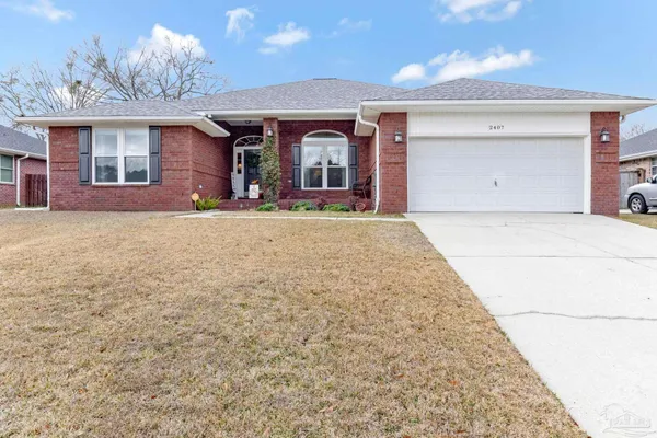 a view of a house with a yard and garage