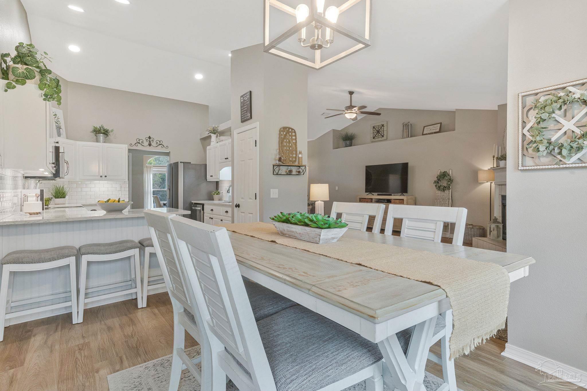 2407 Pine Forest Road Cantonment, FL 32533 - Photo 13 of 60 a view of a dining room with furniture and a chandelier