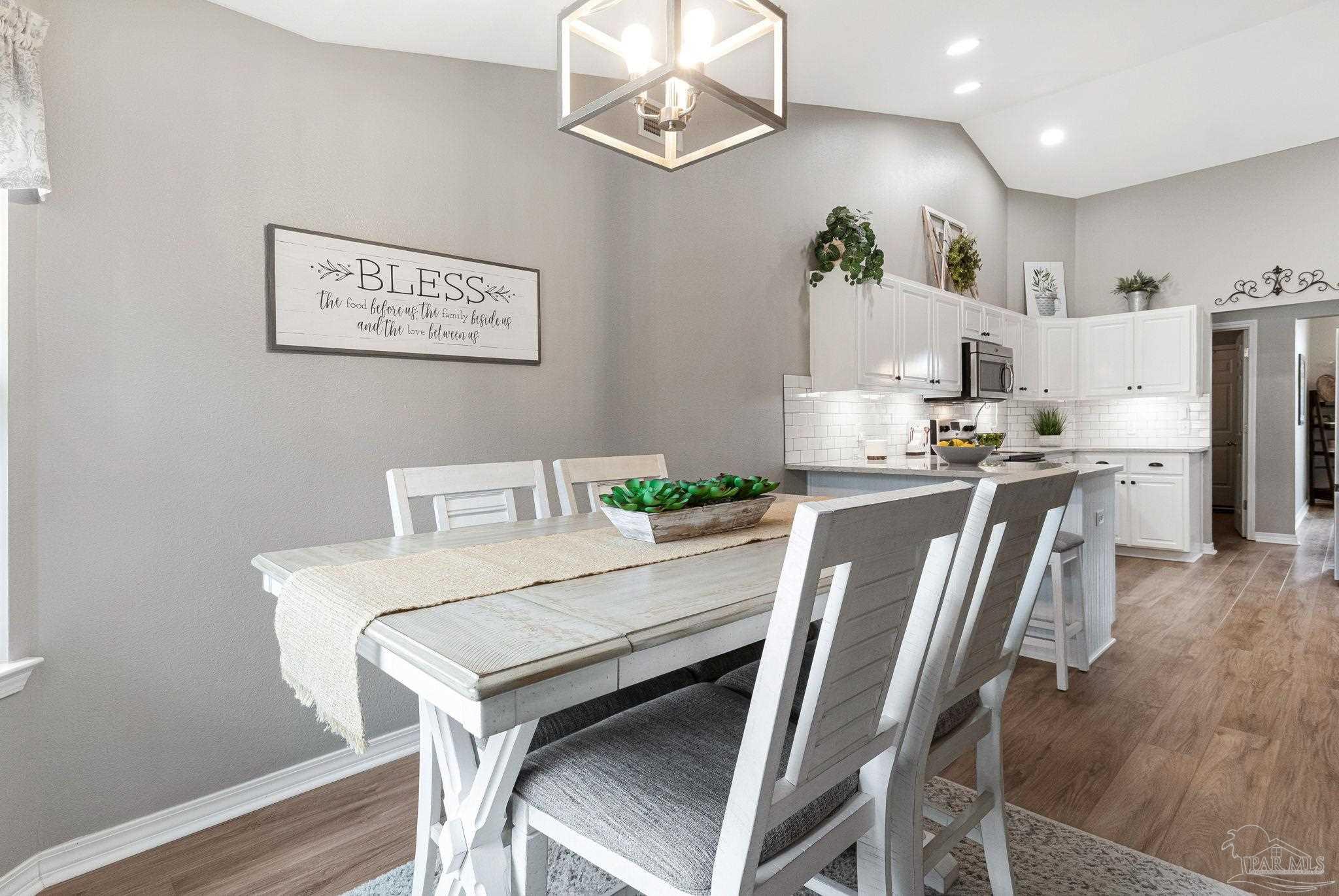2407 Pine Forest Road Cantonment, FL 32533 - Photo 14 of 60 a view of a dining room with furniture and a chandelier