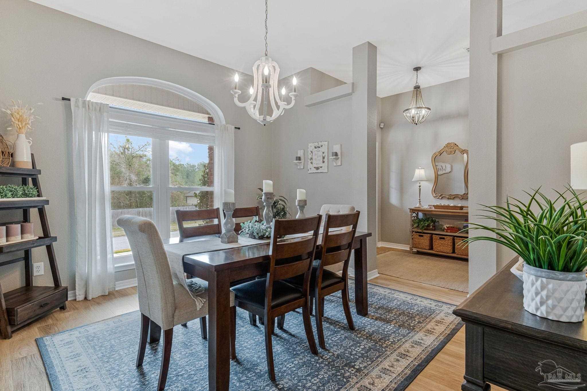 2407 Pine Forest Road Cantonment, FL 32533 - Photo 17 of 60 a view of a dining room with furniture window and wooden floor