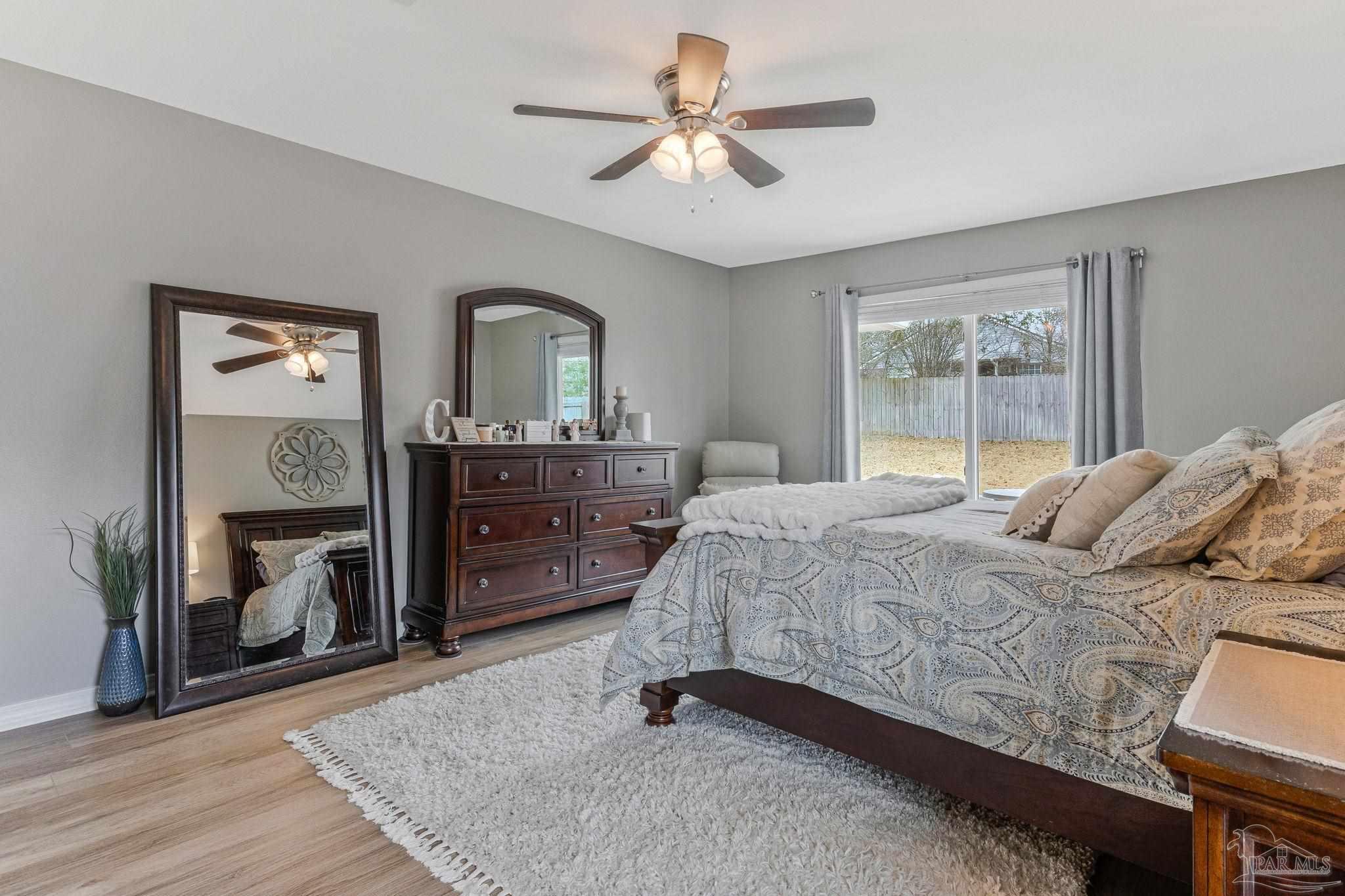 2407 Pine Forest Road Cantonment, FL 32533 - Photo 20 of 60 a bedroom with a bed and a dresser