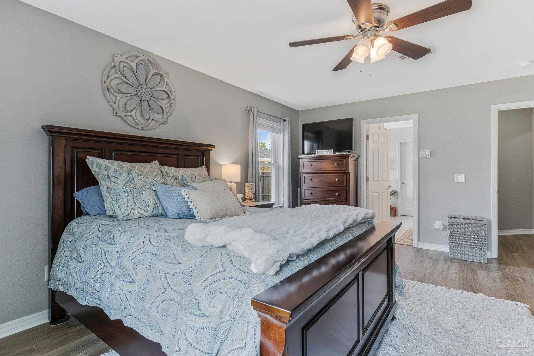 2407 Pine Forest Road Cantonment, FL 32533 - Photo 21 of 60 a bedroom with a bed and a chandelier