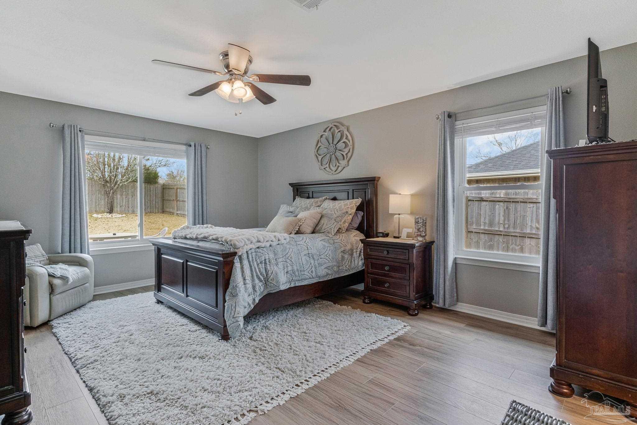 2407 Pine Forest Road Cantonment, FL 32533 - Photo 22 of 60 a bedroom with a bed and wooden floor