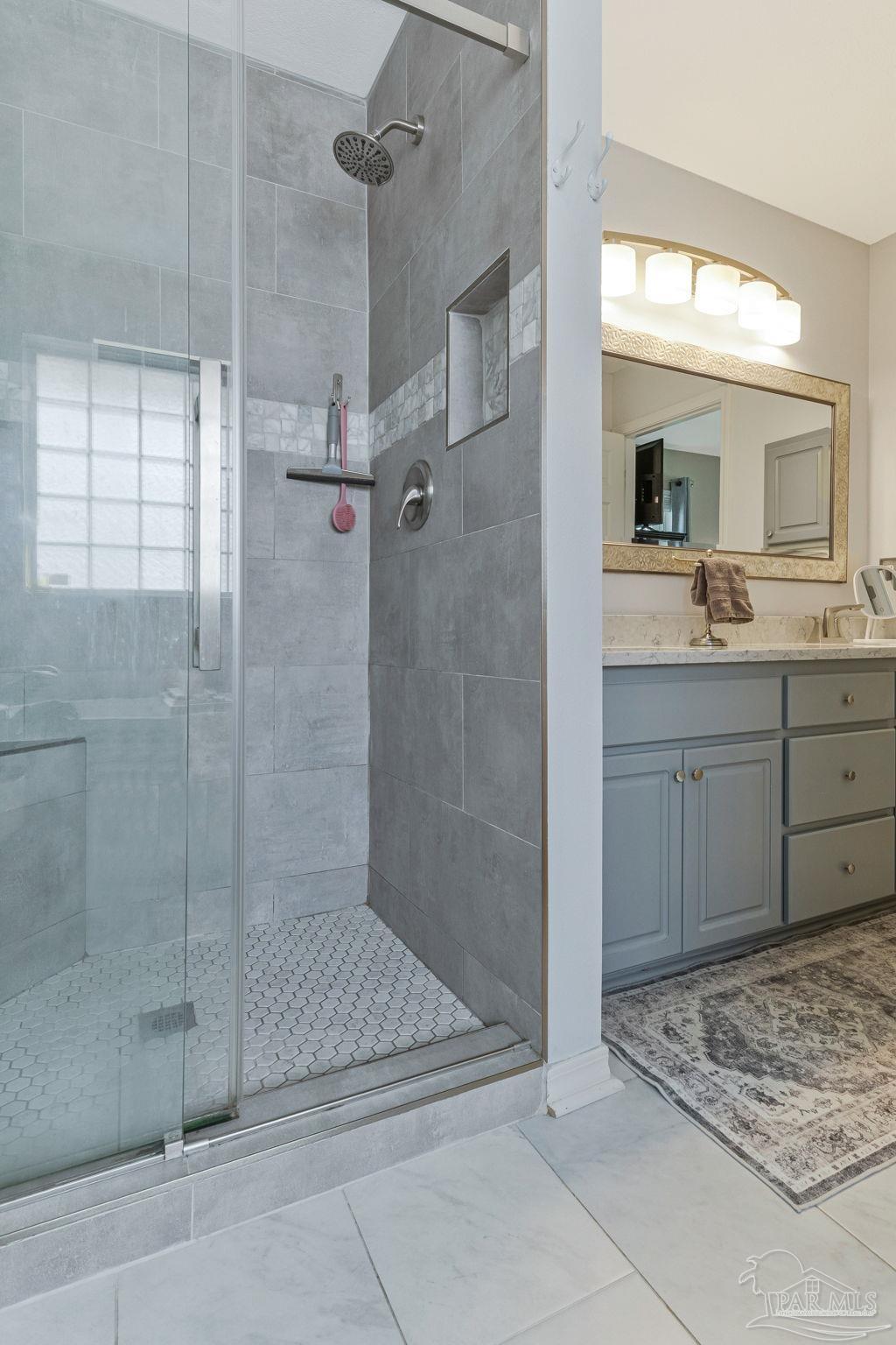 2407 Pine Forest Road Cantonment, FL 32533 - Photo 25 of 60 a bathroom with a shower and a sink