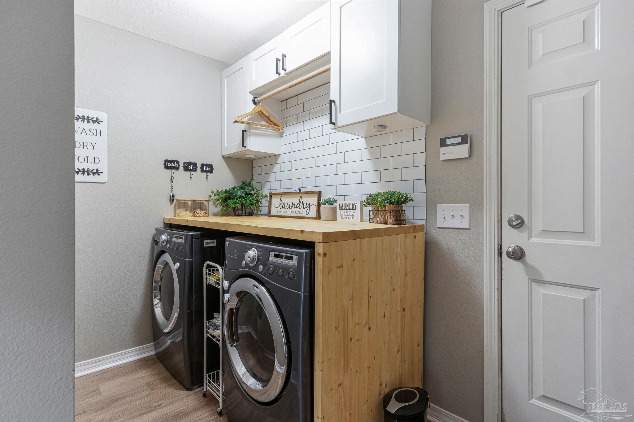 2407 Pine Forest Road Cantonment, FL 32533 - Photo 27 of 60 a utility room with dryer and washer