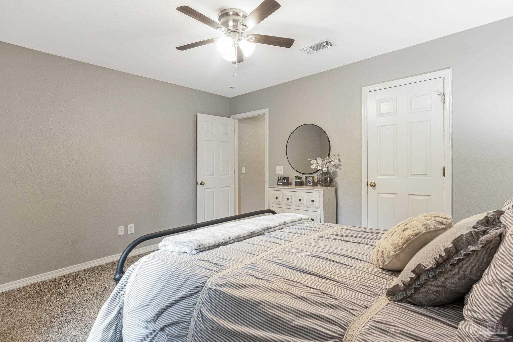 2407 Pine Forest Road Cantonment, FL 32533 - Photo 29 of 60 a bedroom with a bed and a chandelier