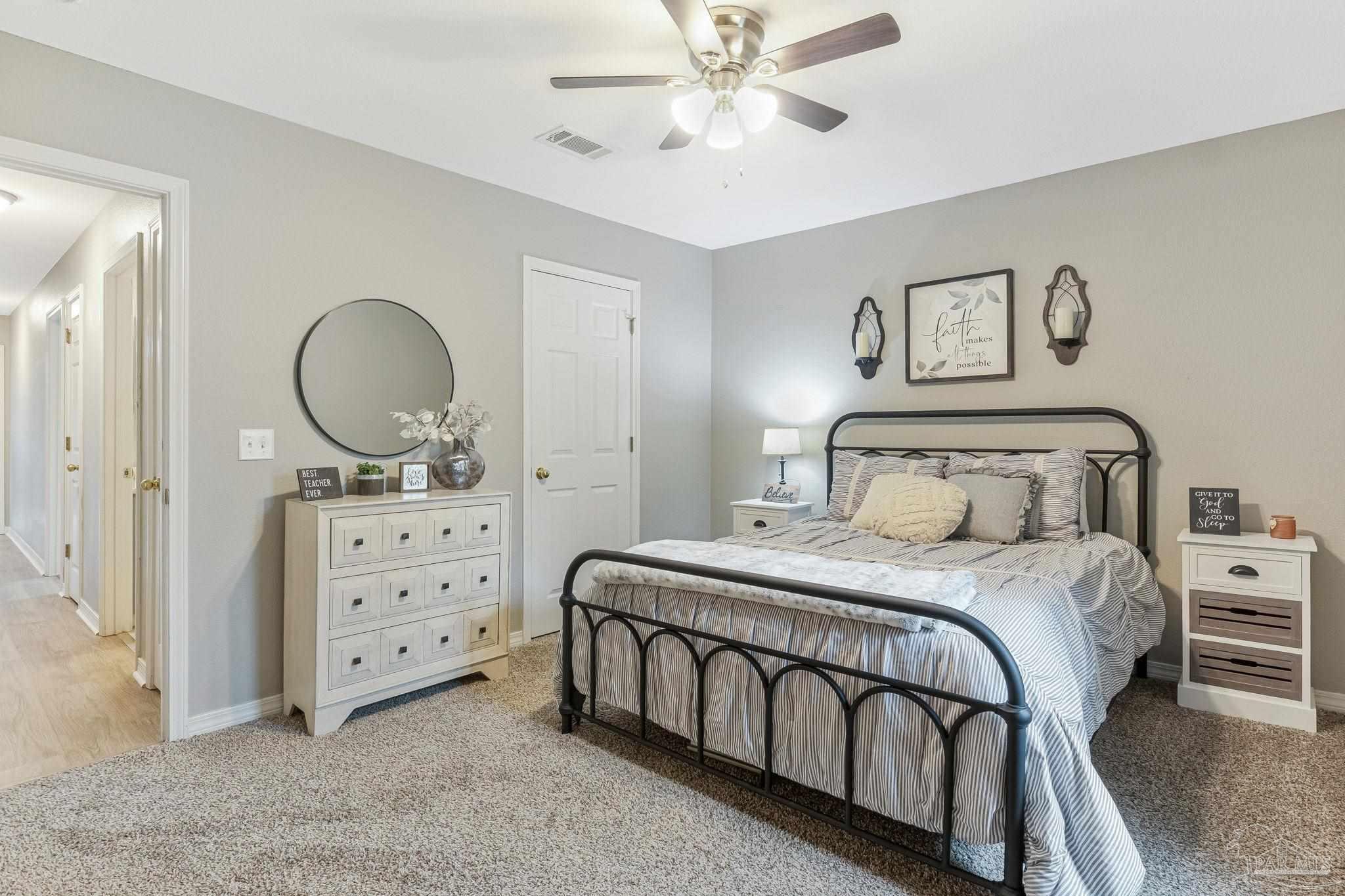 2407 Pine Forest Road Cantonment, FL 32533 - Photo 30 of 60 a bedroom with a bed and a chandelier