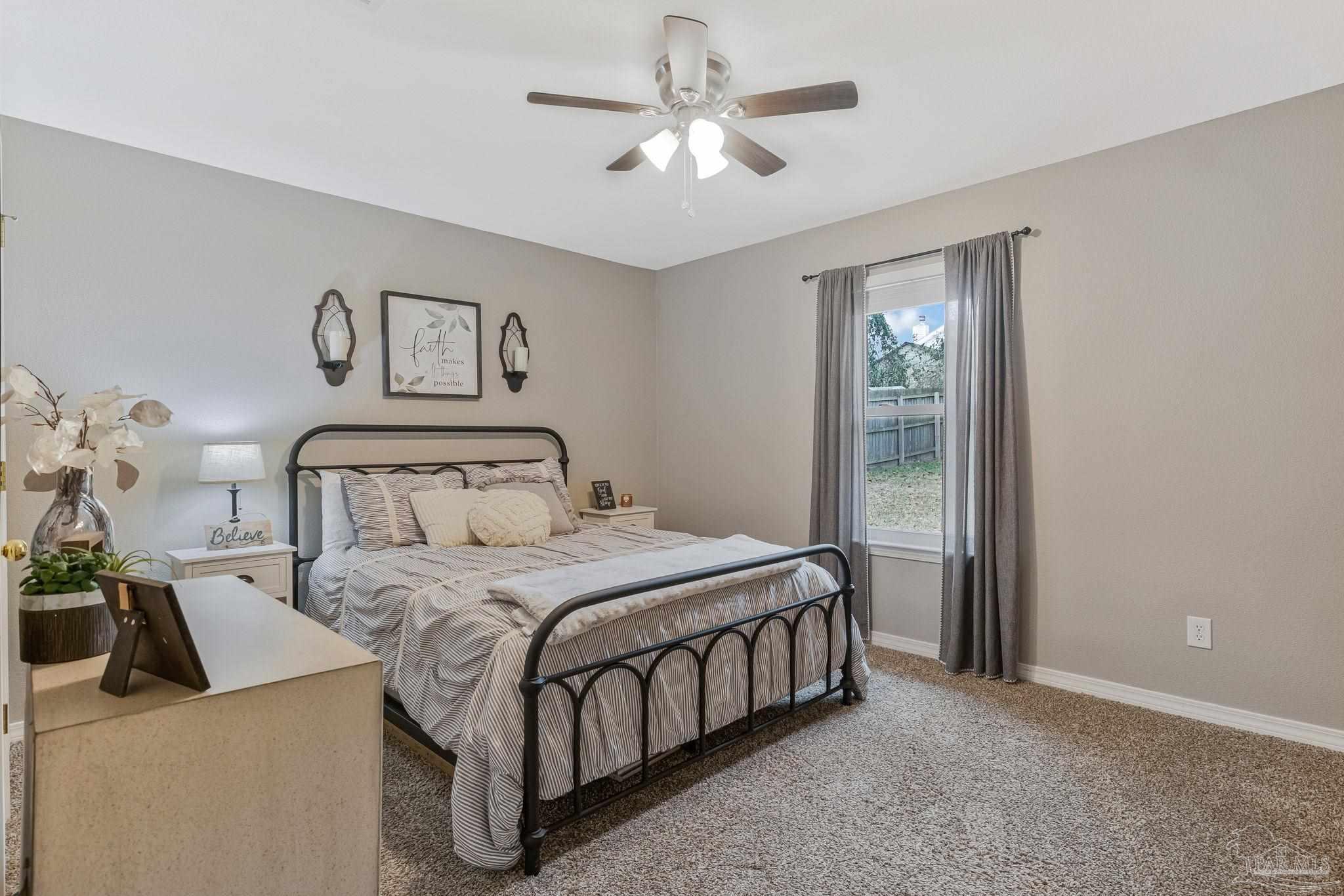2407 Pine Forest Road Cantonment, FL 32533 - Photo 31 of 60 a bedroom with a beds chandelier and a window