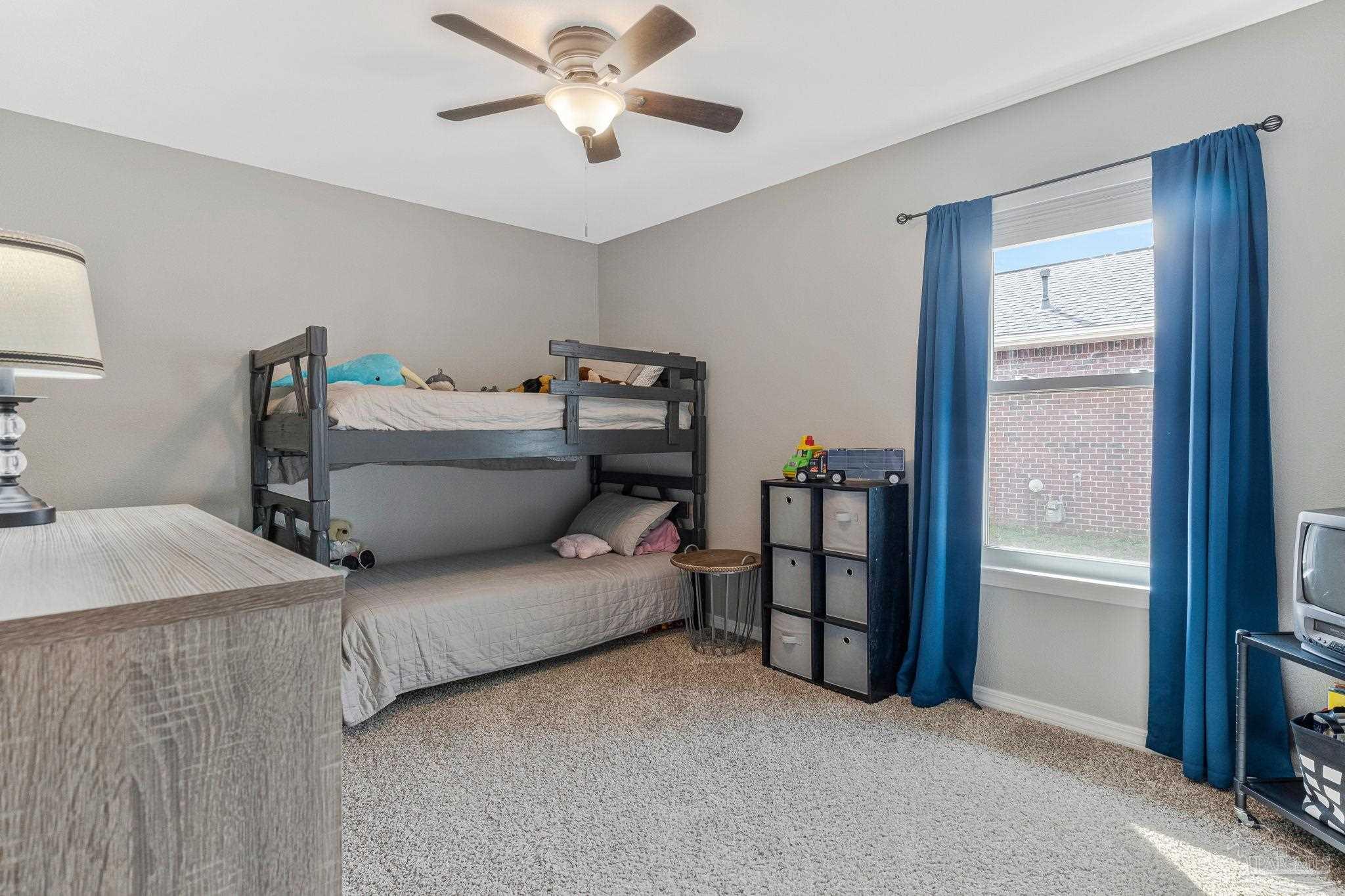 2407 Pine Forest Road Cantonment, FL 32533 - Photo 34 of 60 a living room with furniture and a chandelier
