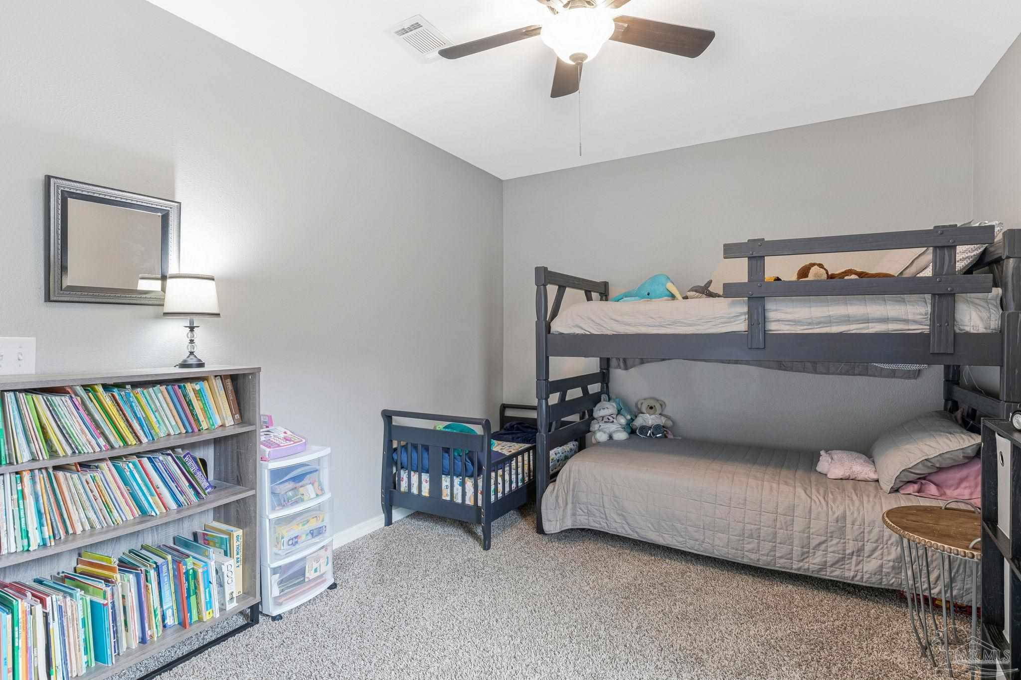 2407 Pine Forest Road Cantonment, FL 32533 - Photo 35 of 60 a living room with furniture and a book shelf