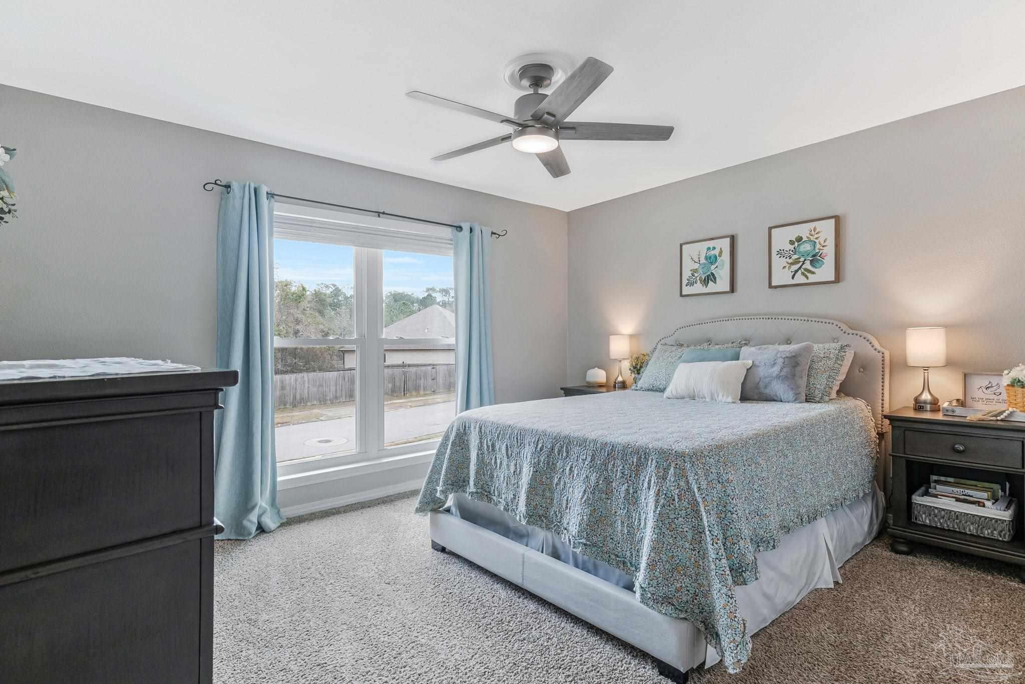 2407 Pine Forest Road Cantonment, FL 32533 - Photo 36 of 60 a spacious bedroom with a bed and a ceiling fan