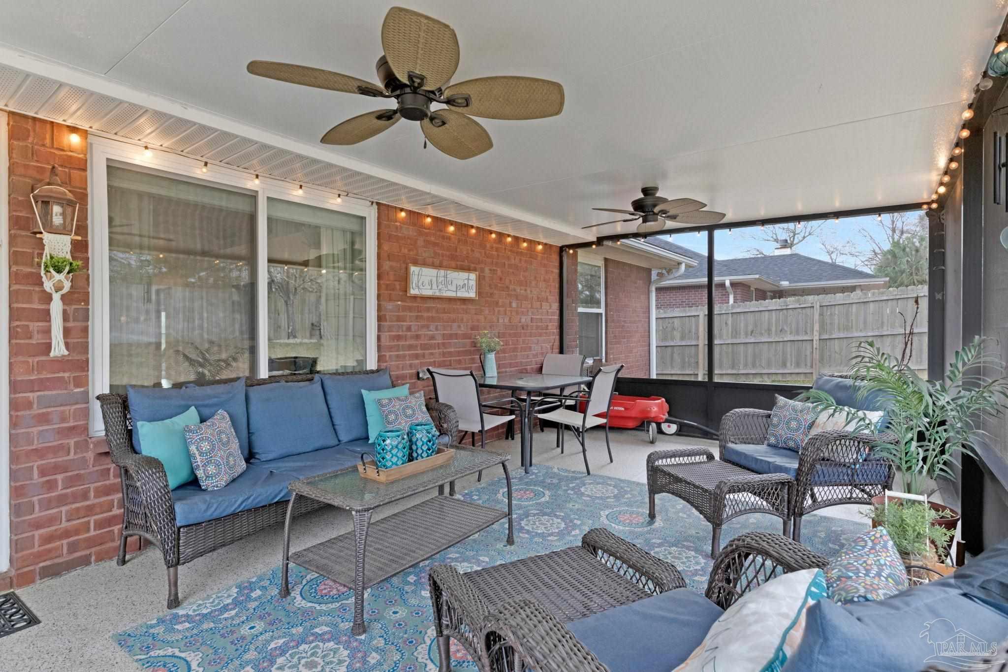 2407 Pine Forest Road Cantonment, FL 32533 - Photo 39 of 60 a living room with furniture and a large window