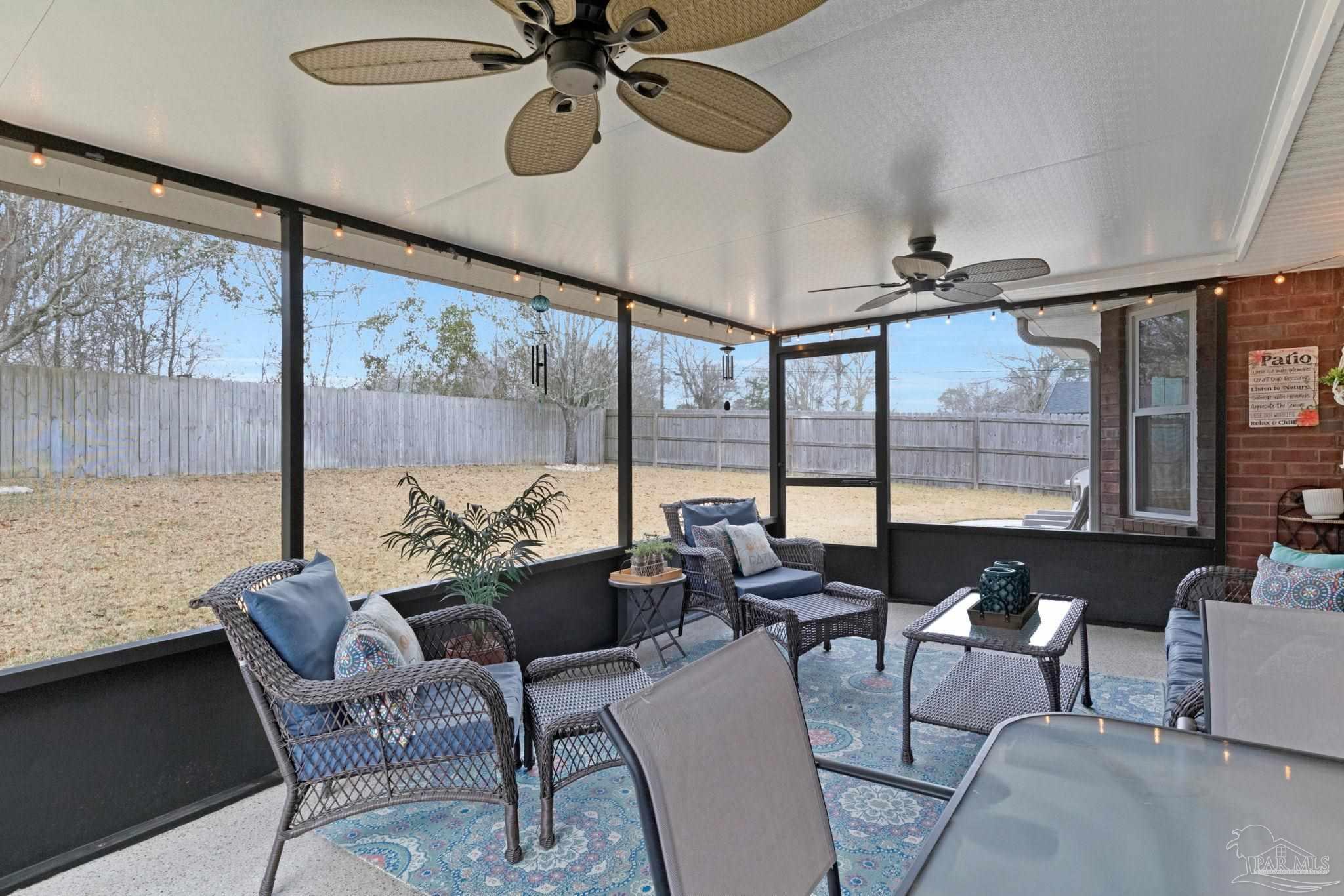2407 Pine Forest Road Cantonment, FL 32533 - Photo 40 of 60 a living room with furniture and a large window
