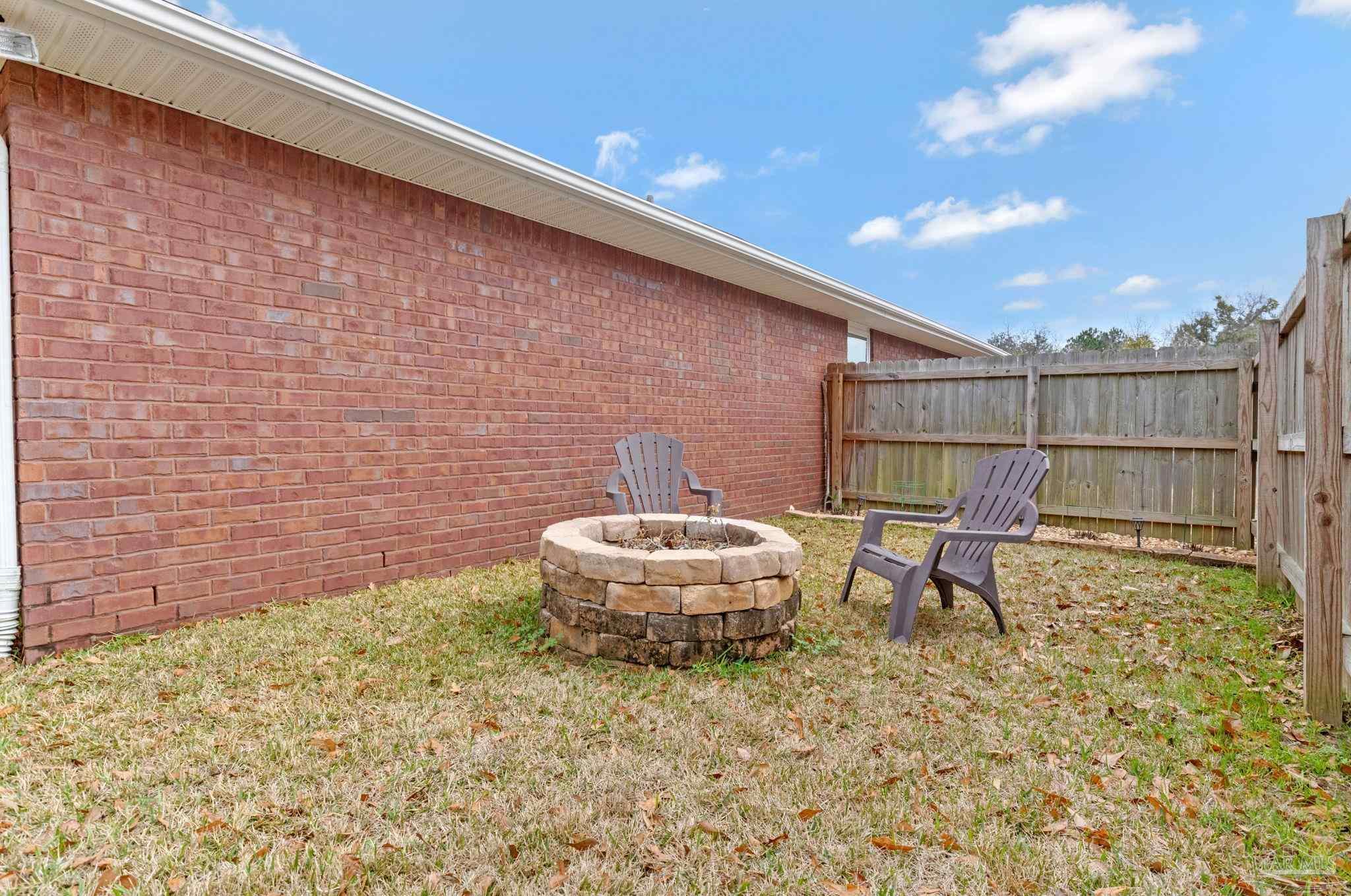 2407 Pine Forest Road Cantonment, FL 32533 - Photo 50 of 60 a backyard of a house with table and chairs