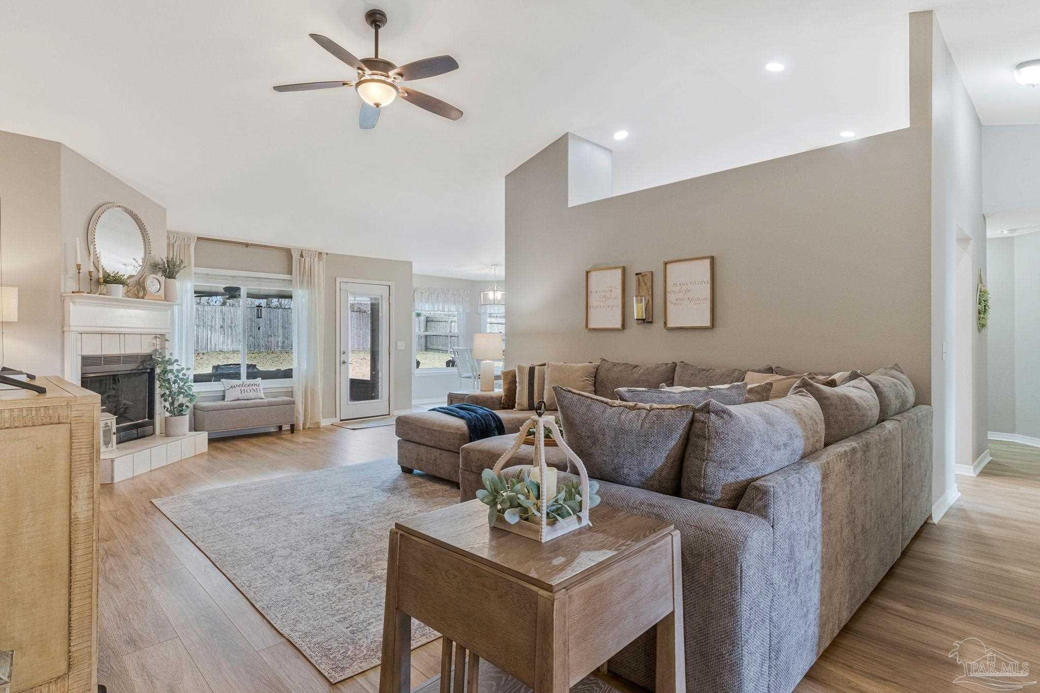 2407 Pine Forest Road Cantonment, FL 32533 - Photo 5 of 60 a living room with furniture fireplace and a chandelier