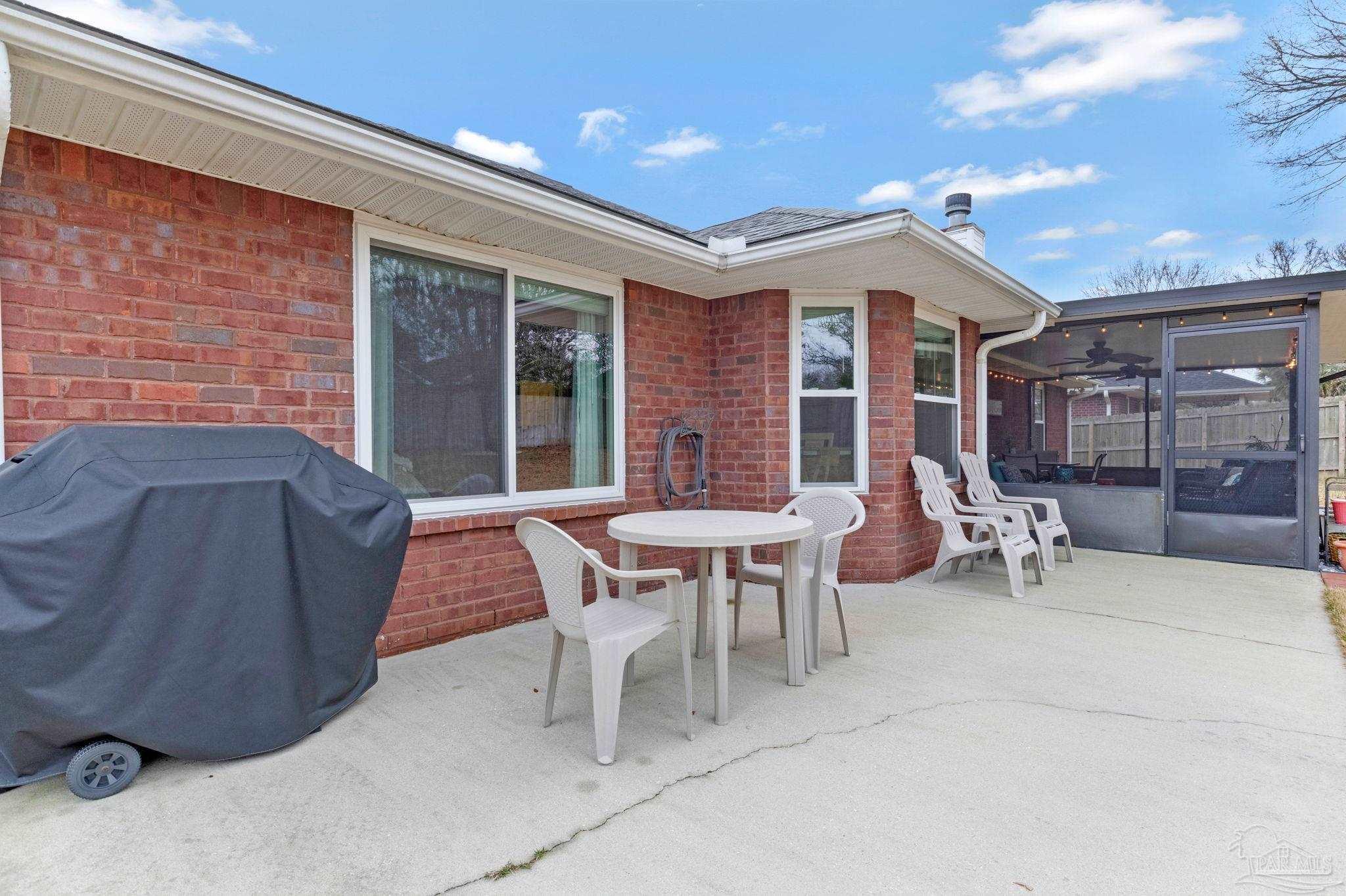 2407 Pine Forest Road Cantonment, FL 32533 - Photo 54 of 60 a view of a house with patio and a yard
