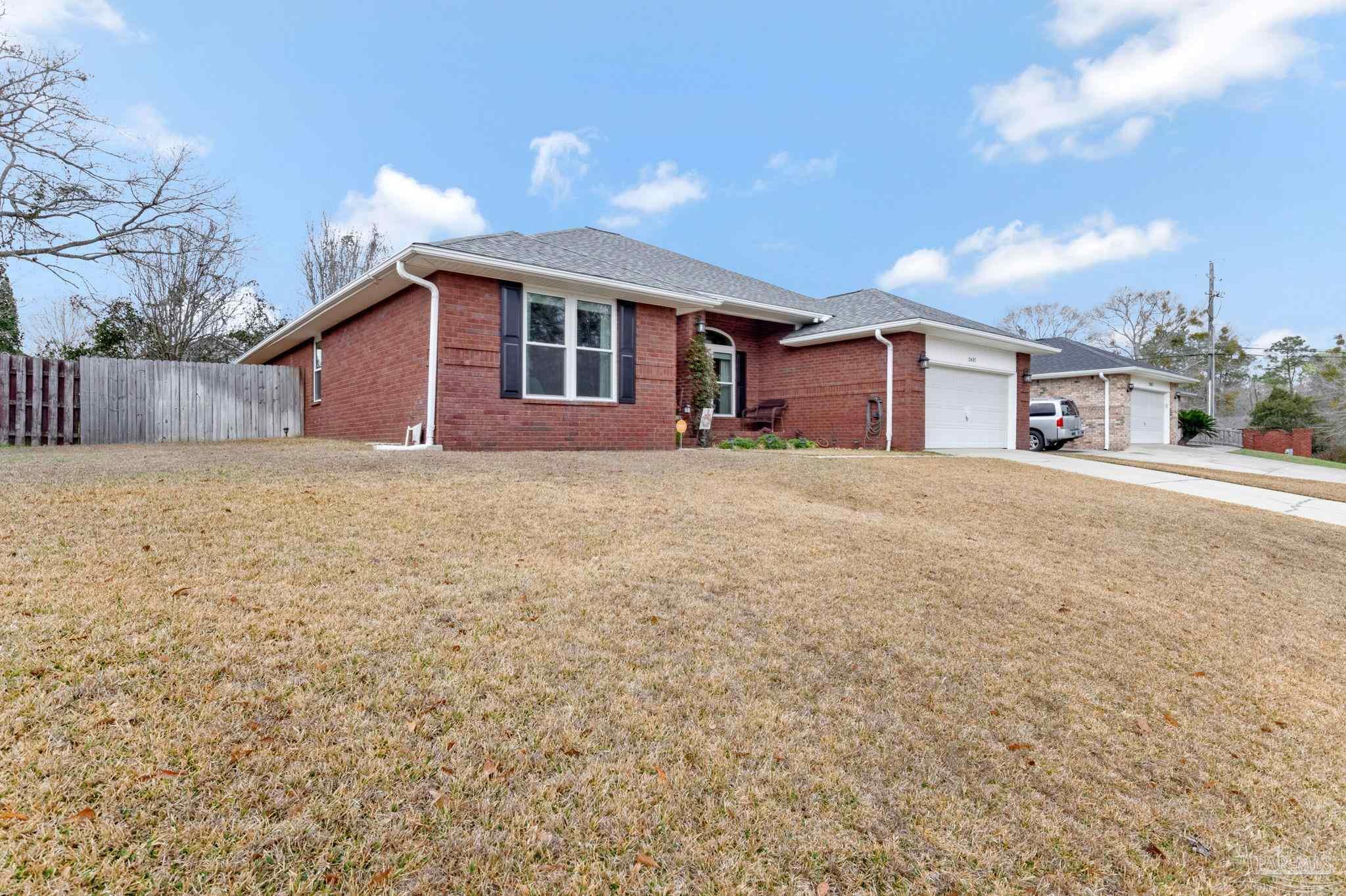 2407 Pine Forest Road Cantonment, FL 32533 - Photo 60 of 60 a large house with a yard and a garage