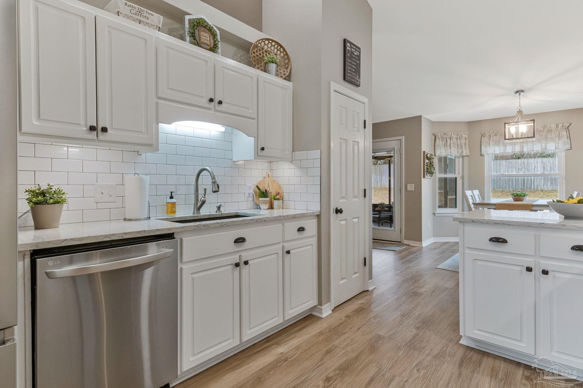 2407 Pine Forest Road Cantonment, FL 32533 - Photo 10 of 60 a kitchen with white cabinets and appliances