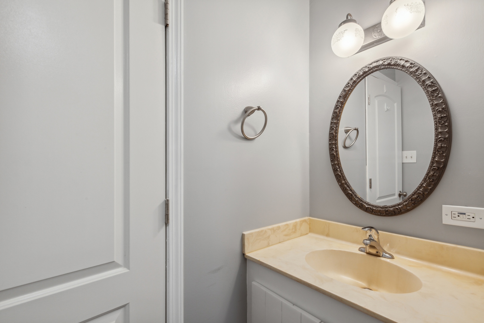 1464 Stonebridge Circle, Unit E2 Wheaton, IL 60189 - Photo 11 of 14 a bathroom with a sink and a mirror