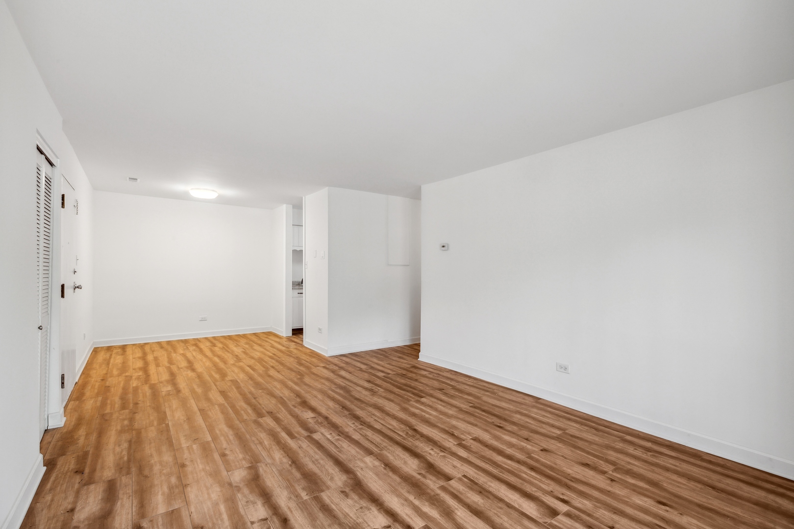 1464 Stonebridge Circle, Unit E2 Wheaton, IL 60189 - Photo 2 of 14 a view of empty room with wooden floor