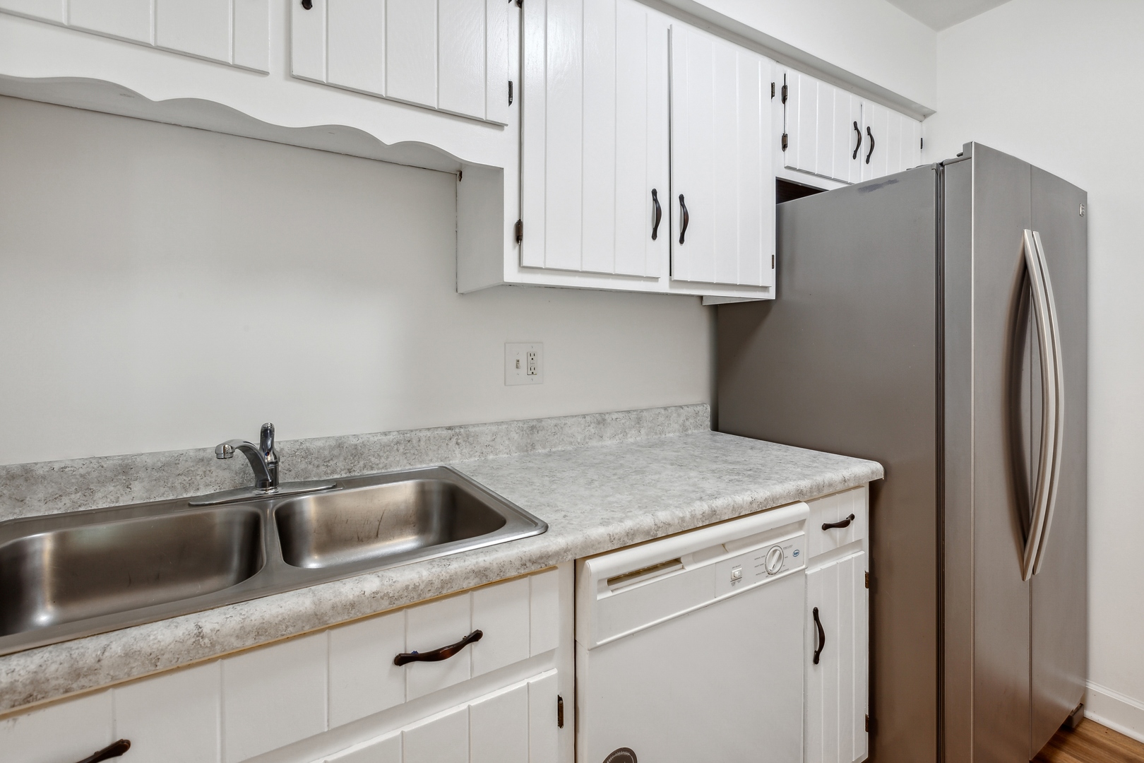 1464 Stonebridge Circle, Unit E2 Wheaton, IL 60189 - Photo 5 of 14 a kitchen with stainless steel appliances white cabinets and a sink
