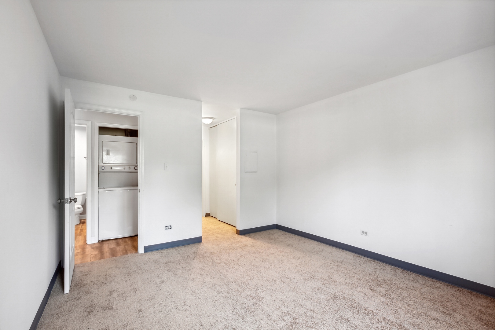 1464 Stonebridge Circle, Unit E2 Wheaton, IL 60189 - Photo 7 of 14 an empty room with a natural light