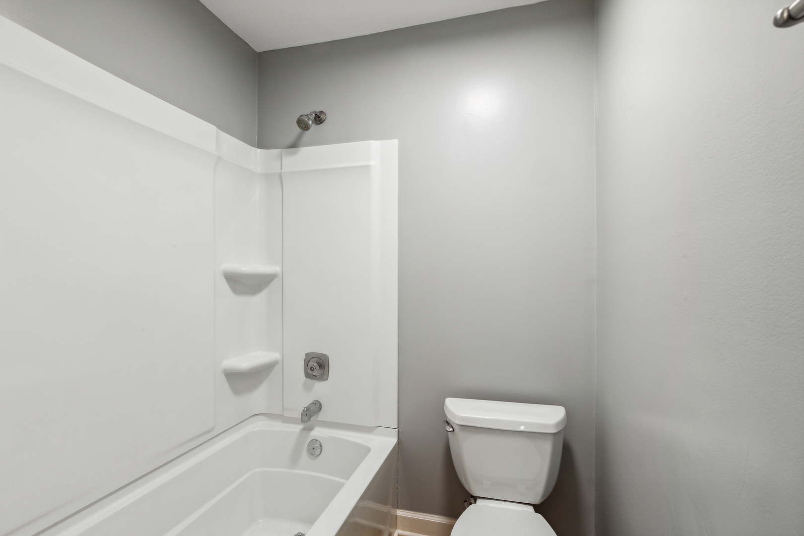 1464 Stonebridge Circle, Unit E2 Wheaton, IL 60189 - Photo 10 of 14 a bathroom with a toilet a sink and a bathtub