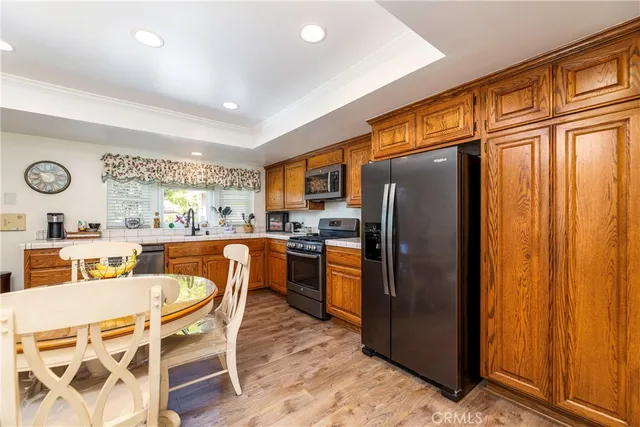 a kitchen with stainless steel appliances granite countertop a refrigerator and a stove top oven