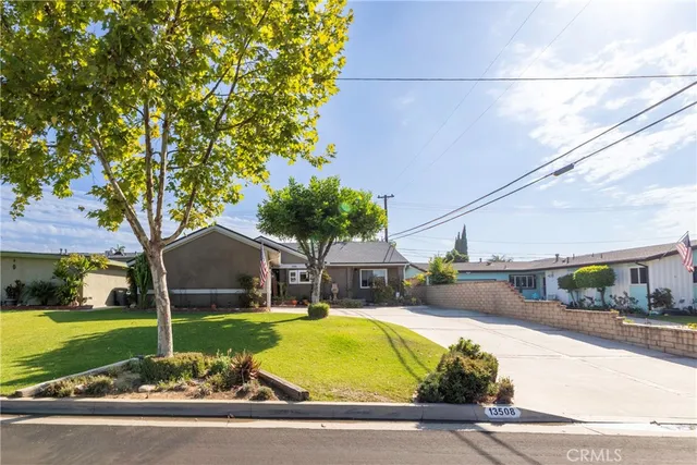 a house view with a swimming pool next to a yard