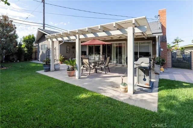 a view of a patio with table and chairs and potted plants