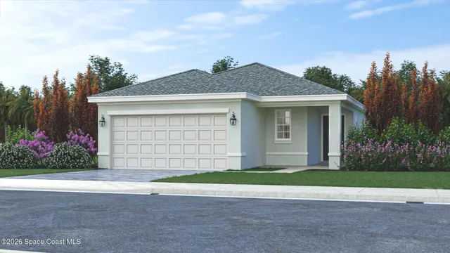 a front view of a house with a garden and yard