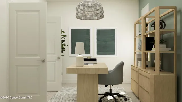 a view of a workspace with furniture and a window