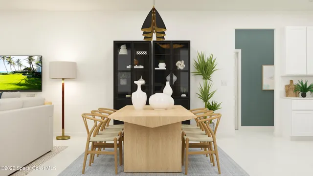 a view of a dining room with furniture and chandelier