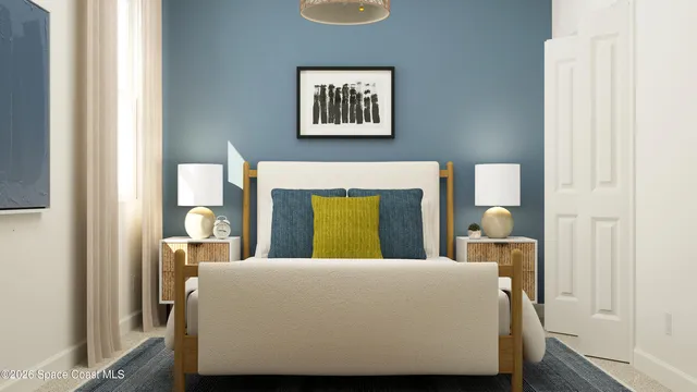 a bedroom with a bed and painting on the wall