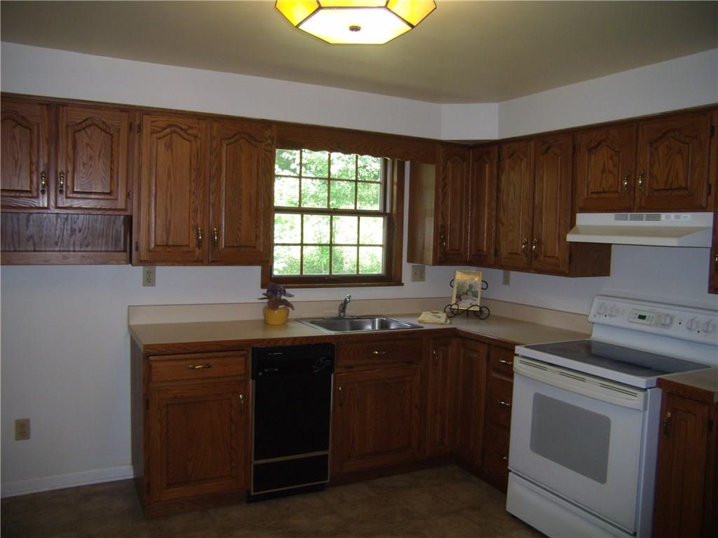 712 Ramon Drive Pittsburgh, PA 15238 - Photo 7 of 25 The eat-in kitchen has lots of wood cabinetry and counter space, plus space to what you like.