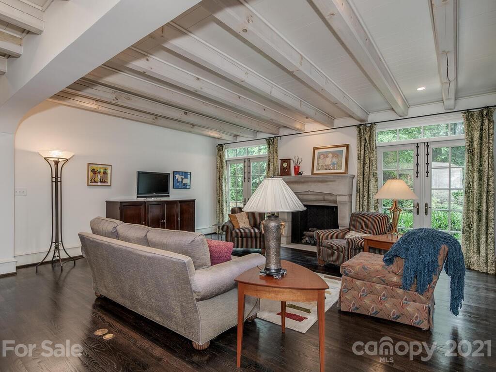 1056 Bolling Road Charlotte, NC 28207 - Photo 11 of 48 a living room with furniture a lamp wooden floor and a large window