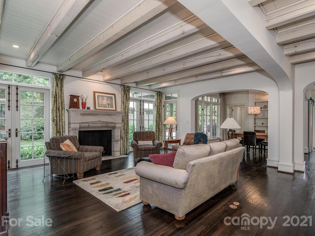 1056 Bolling Road Charlotte, NC 28207 - Photo 12 of 48 a living room with furniture a fireplace and wooden floor