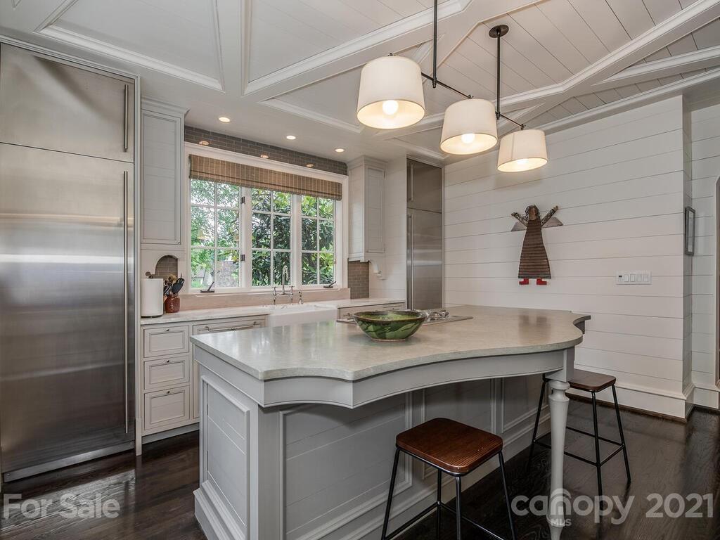 1056 Bolling Road Charlotte, NC 28207 - Photo 16 of 48 a kitchen with a table and chairs in it