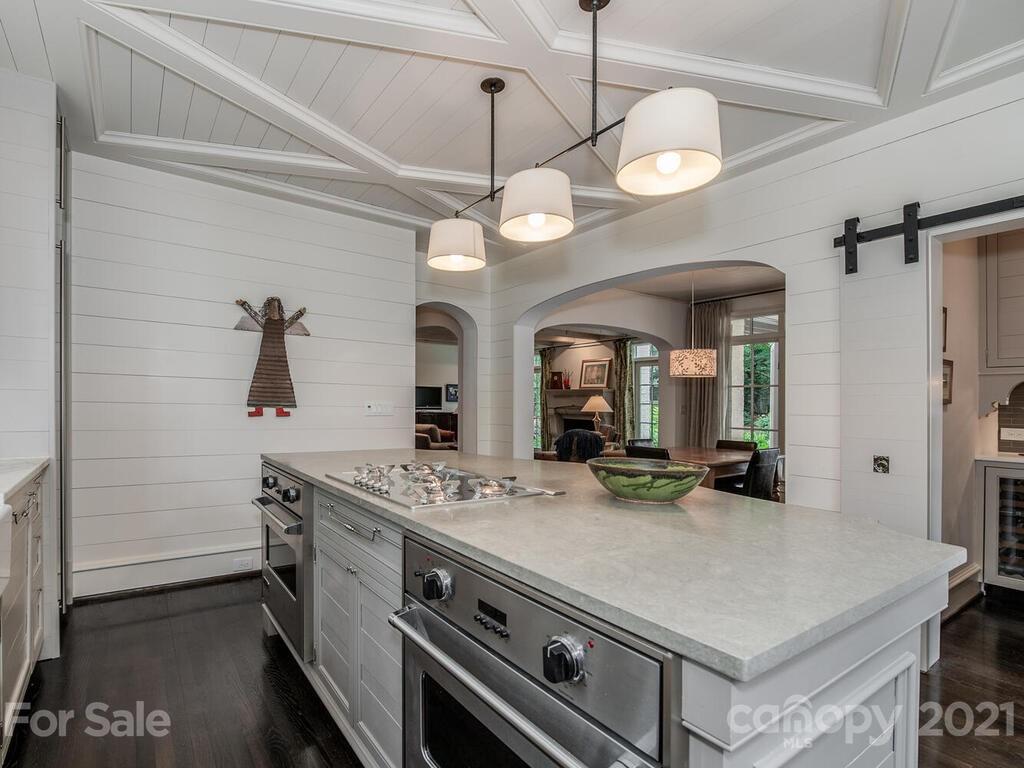 1056 Bolling Road Charlotte, NC 28207 - Photo 18 of 48 a view of a center island and chandelier