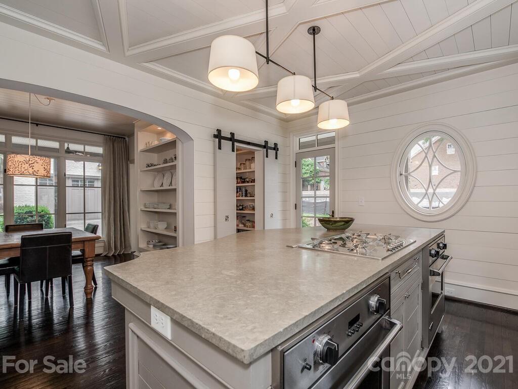 1056 Bolling Road Charlotte, NC 28207 - Photo 19 of 48 a kitchen with a table chairs and a chandelier