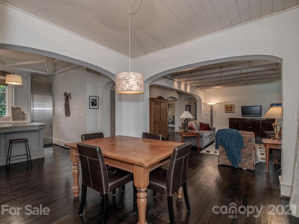 1056 Bolling Road Charlotte, NC 28207 - Photo 21 of 48 a view of a dining room with furniture wooden floor and chandelier