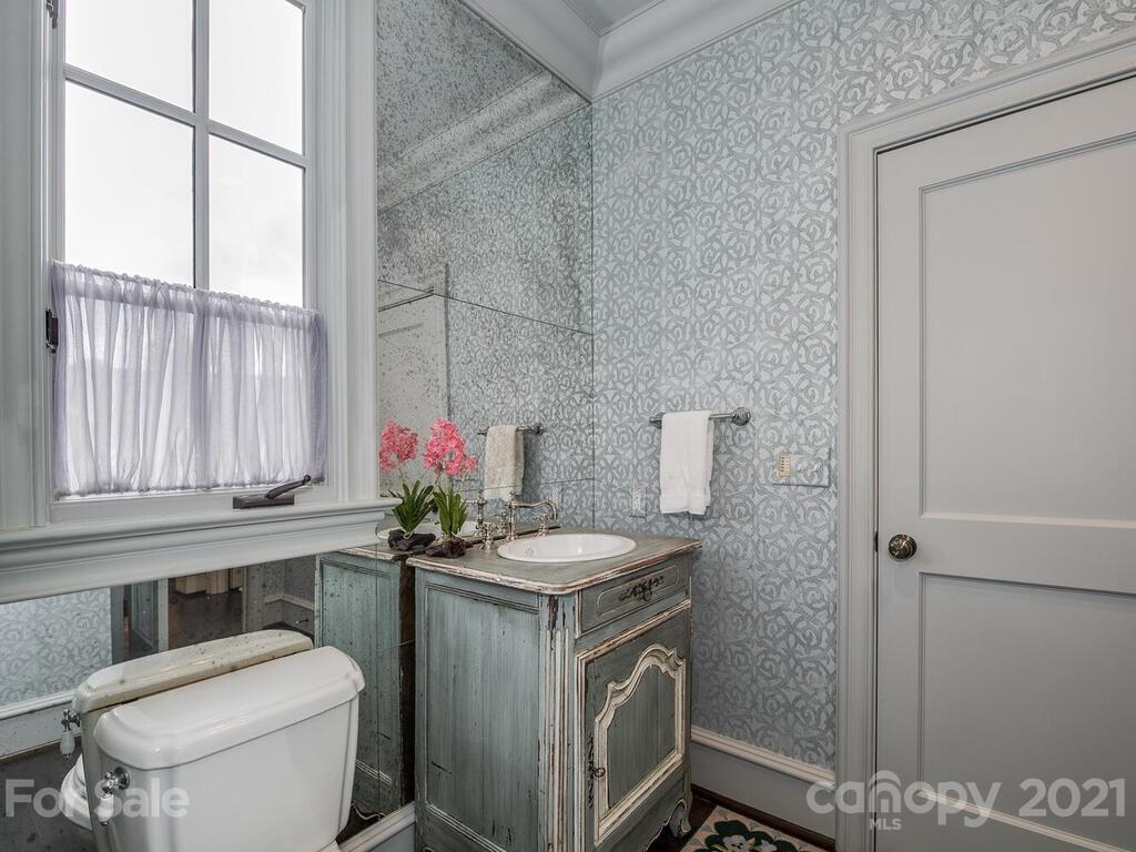 1056 Bolling Road Charlotte, NC 28207 - Photo 27 of 48 a bathroom with a sink toilet and window