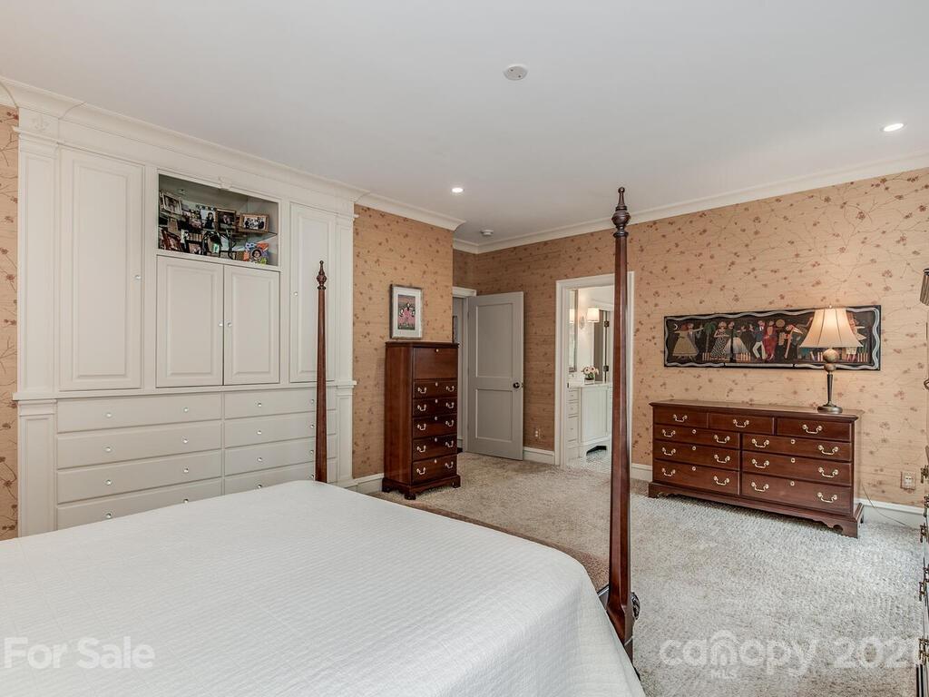 1056 Bolling Road Charlotte, NC 28207 - Photo 30 of 48 a bedroom with a bed and a dresser