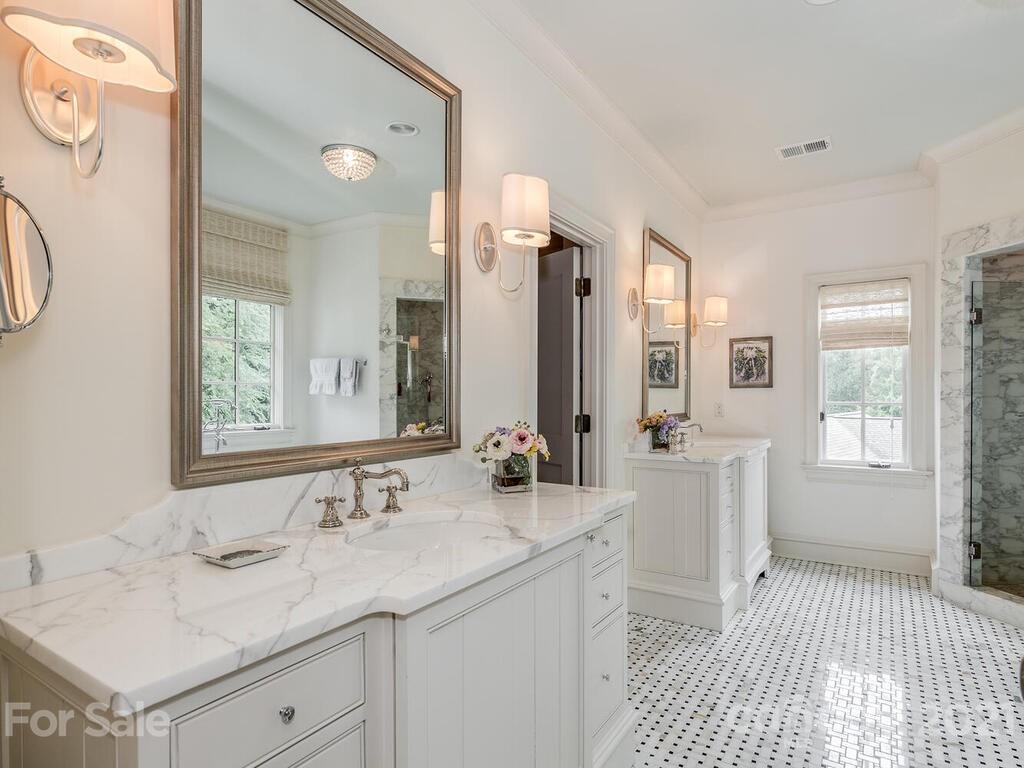 1056 Bolling Road Charlotte, NC 28207 - Photo 31 of 48 a bathroom with a sink vanity granite tub and a mirror
