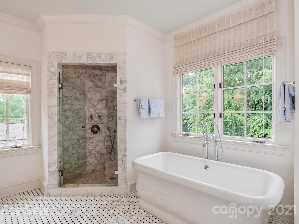 1056 Bolling Road Charlotte, NC 28207 - Photo 32 of 48 a white bath tub sitting next to a shower