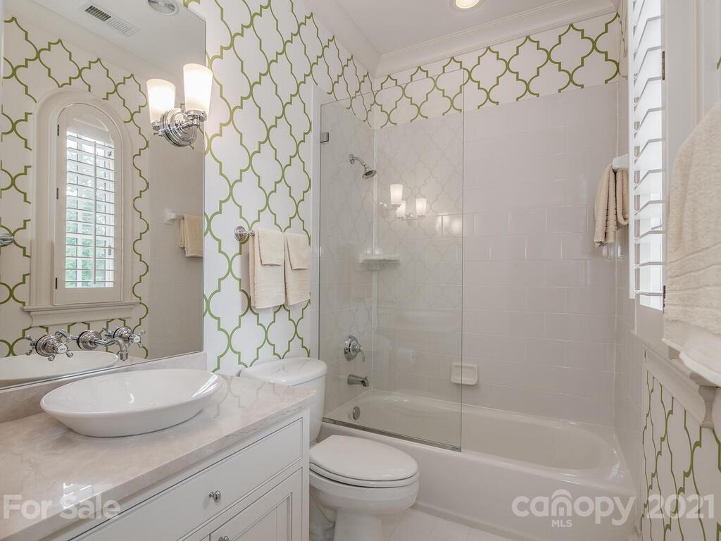 1056 Bolling Road Charlotte, NC 28207 - Photo 36 of 48 a bathroom with a granite countertop sink a toilet and shower